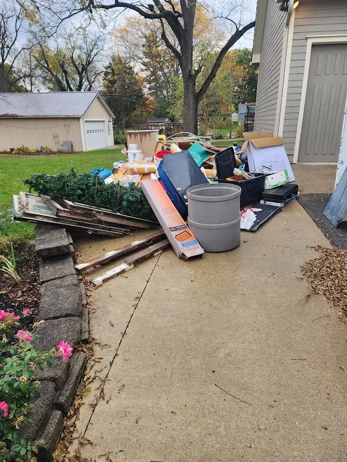Dumpster being loaded with debris for 3 Yard Dumpster Rental in Burlington